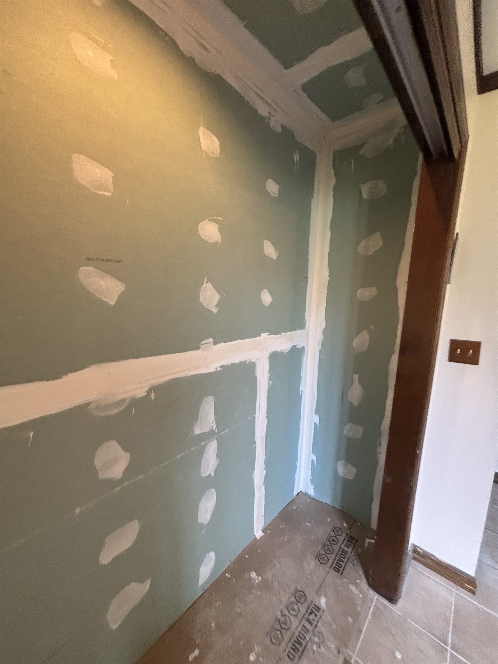 Closet drywall with joint compound and floor protection