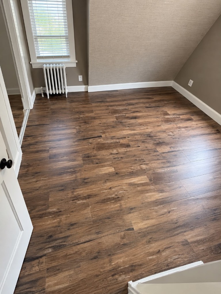 Luxury vinyl plank flooring in an attic bedroom