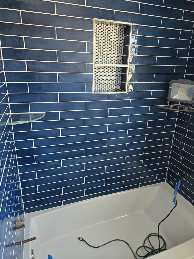 Navy tile bathroom renovation in progress